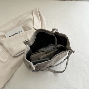 Silver metallic leather tote bag with chain strap showing spacious interior capacity