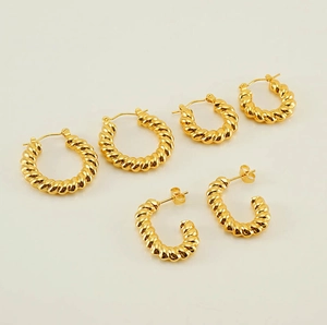 Detailed set of three golden twisted rope hoop earrings and C-shaped studs for women