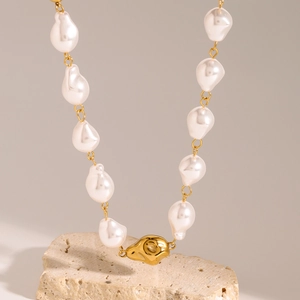 Elegant gold-tone stainless steel necklace with baroque pearls and a unique organic pendant