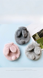 Soft faux rabbit fur hot water bottle covers in pink and grey showing plush texture