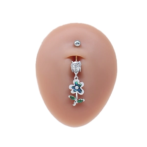 Close-up of silver belly ring with green floral tassel pendant on silicone model