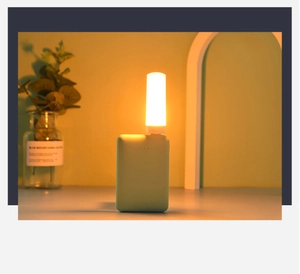 USB warm yellow night light with dynamic flame effect plugged into a green power bank