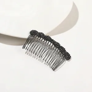 Close-up of black rhinestone metal hair comb with multi-tooth structure on white base