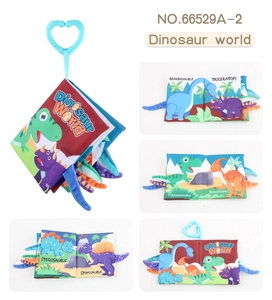 Detailed views of dinosaur tail cloth book with 3D tails and a hanging heart clip