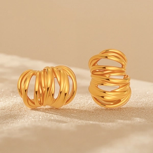 Modern gold C-shaped earrings featuring textured multi-layer coiled wire design