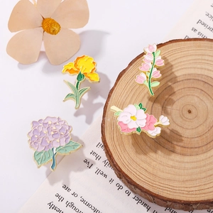 Exquisite set of four floral enamel brooches with gold plating and colorful flower designs