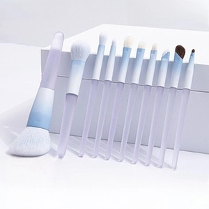 Detail view of 10 gradient makeup brushes set including eye and powder brushes on a white stand