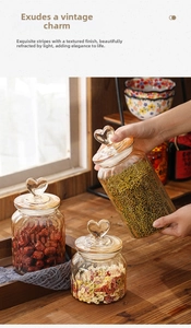Macro view of amber glass storage jars with heart handles and vertical ribbed texture