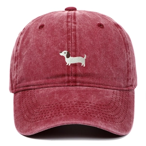 Macro detail of dachshund embroidery on vintage washed cotton baseball cap in burgundy red