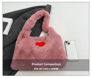 Pink faux fur handbag with red heart patch showing size scale next to a smartphone