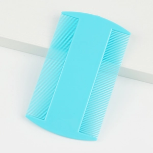 Detail of blue double-sided fine-toothed pet flea comb on a clean white background