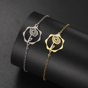 Detail of silver and gold stainless steel chain bracelets with sunflower charm pendants