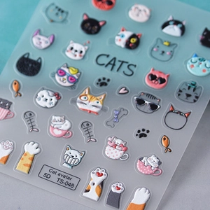 Close-up of 5D embossed cat nail stickers featuring cute kitten heads and fish bone patterns