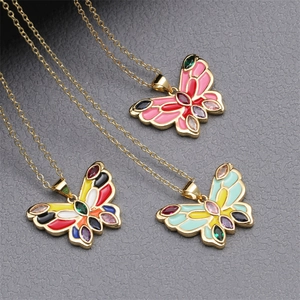 Colorful enamel butterfly necklaces with gold plating and multicolor gemstones on gray background
