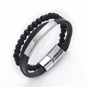 Macro shot of multi-layer leather bracelet with matte stone beads and stainless steel clasp