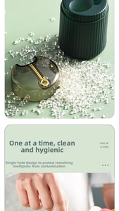 Detail of single-hole automatic toothpick dispenser showing dark green texture