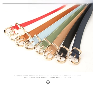 Detailed view of colorful PU leather skinny belts featuring elegant gold D-ring buckles