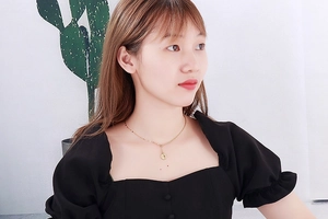 Golden stainless steel necklace with coin pendant shown on a model neck for size reference