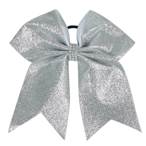 Close-up of silver sequin hair bow with rhinestone center and black elastic band