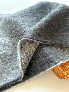 Close-up of soft grey pashmina scarf texture with premium cashmere-like wool fibers