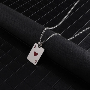Macro detail of silver ace of hearts poker card pendant on a titanium steel necklace