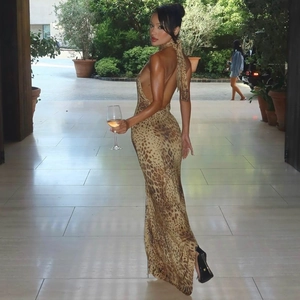 Detail showing the sexy backless design and halter neck of the leopard print midi dress