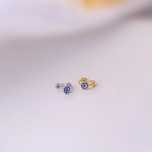 Minimalist gold and silver smiley face hoop earrings with blue enamel finish