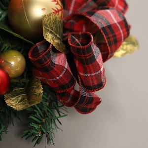 Christmas teardrop swag with red plaid bow, gold ornaments, and green pine needles