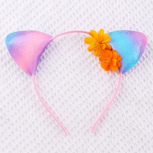 Close-up of pink glitter cat ear headband with orange floral details and sequins