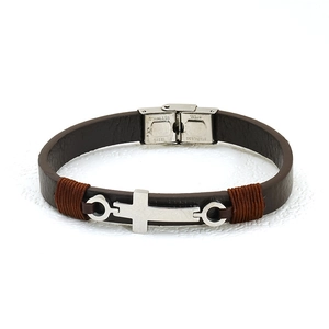 Detail of dark brown leather bracelet with silver cross and stainless steel clasp