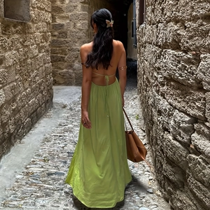 Deep V-neck backless lime green maxi dress with tie straps and flowing silk texture