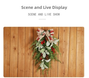 Detail of Christmas swag with pine cones, red berries and Merry Christmas ribbon