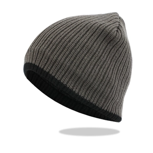 Detail of ribbed knit beanie texture in dark grey and black with elastic winter warmth