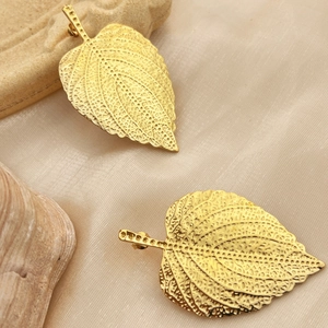 Elegant 18K gold-plated stainless steel leaf earrings on a champagne silk background