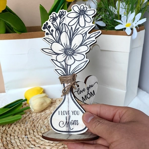 Close-up of wooden flower ornament with Love You Mom engraving and heart tag for home decor