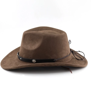 Detailed macro view of a brown suede cowboy hat featuring a silver sun emblem and hatband