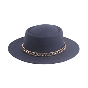 Detail of navy pork pie hat featuring flat top and dual-tone metal chain accessory