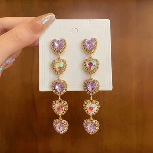 Elegant gold heart tassel earrings with purple crystals and long dangling drop design