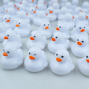 Bulk creative yellow-beaked white duck toy models with a playful winking expression