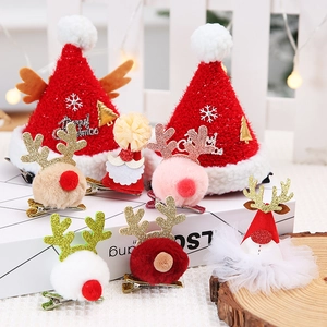 Christmas hair clips set with red plush hats and reindeer antlers on a festive background