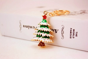Close-up of sparkling rhinestone Christmas tree keychain with colorful enamel on metal