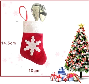 Detail showing red felt Christmas stocking cutlery holder dimensions 14.5cm by 10cm
