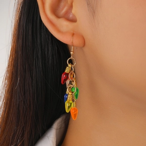 Close-up of vibrant colorful light bulb dangle earrings worn by a female model