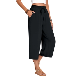 Detail of black wide-leg linen pants featuring elastic drawstring waist and side pockets