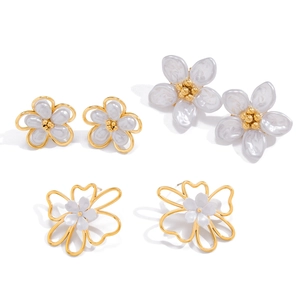 Three pairs of floral 18K gold stainless steel earrings with opal finish on white background