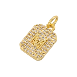 Detailed close-up of gold square pendant with letter M and micro-pave cubic zirconia