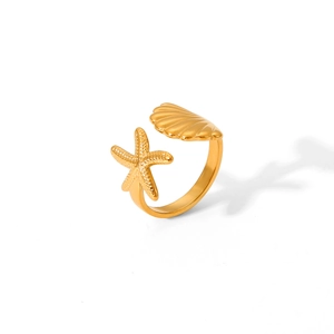 Anello aperto in acciaio inox dorato con stella marina e conchiglia in stile marittimo