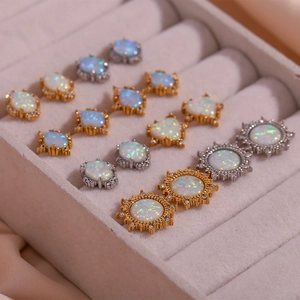 Detailed close-up of gold and silver opal studs in oval, sunflower and heart shapes