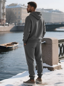 Detailed close-up of dark grey textured jacquard fabric on men hoodie and jogger set