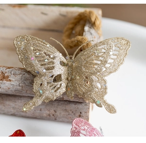Detailed close-up of golden glitter butterfly ornament with cutout design for Christmas tree